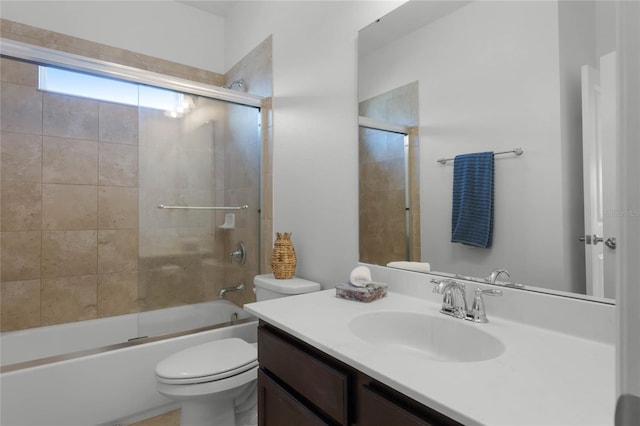 full bathroom featuring bath / shower combo with glass door, vanity, and toilet