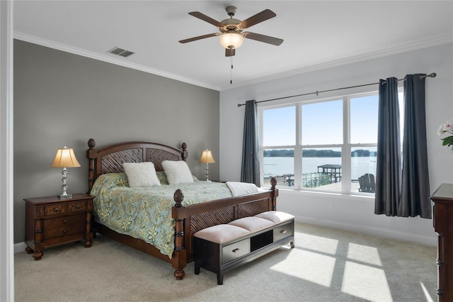 bedroom featuring light carpet, ornamental molding, and a water view