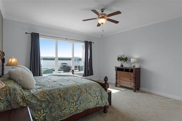 bedroom featuring a water view, ceiling fan, ornamental molding, and carpet