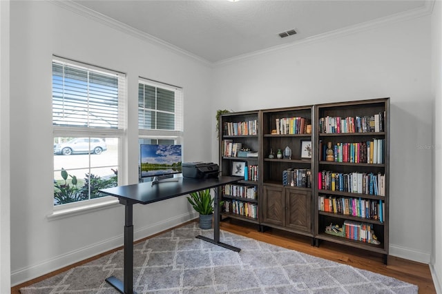 home office featuring hardwood / wood-style flooring and crown molding