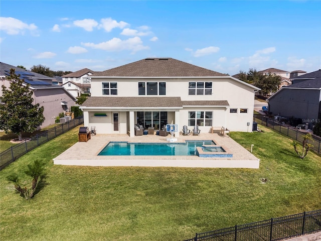 back of house featuring a patio, a yard, an outdoor hangout area, and a pool with hot tub