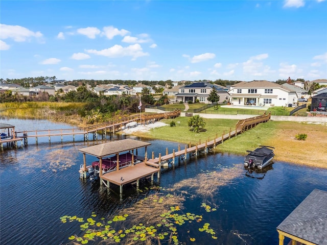 view of dock featuring a water view and a yard