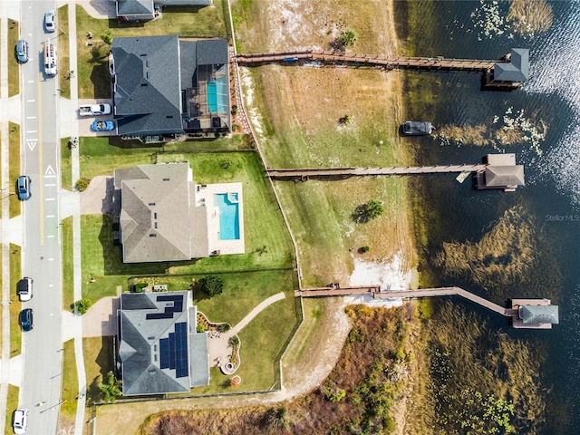 birds eye view of property with a water view