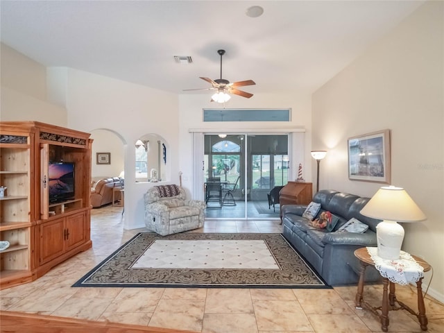 tiled living room with ceiling fan