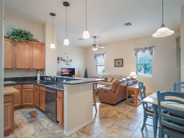 kitchen featuring kitchen peninsula, ceiling fan, dishwasher, dark stone counters, and pendant lighting