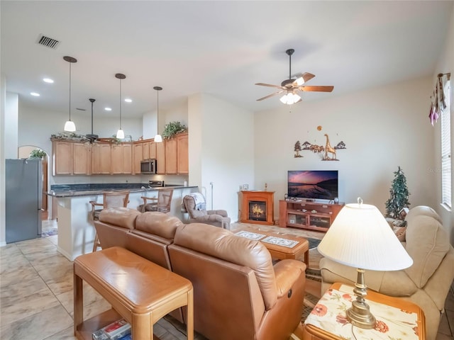 living room with ceiling fan and light tile patterned floors