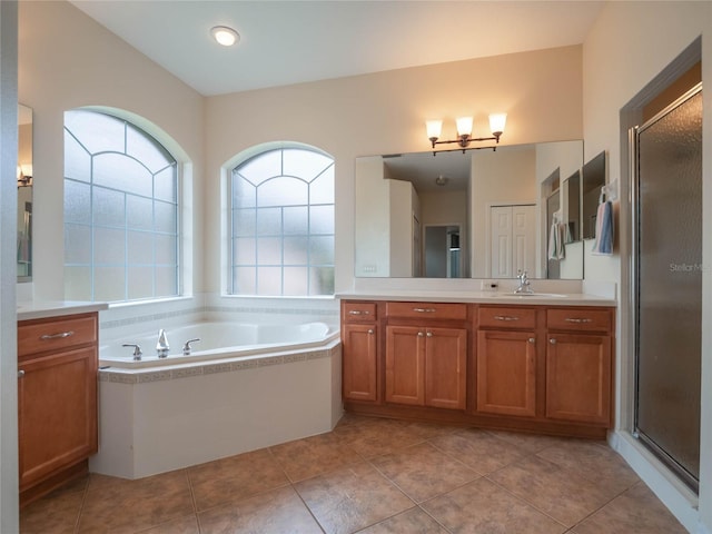 bathroom featuring vanity, tile patterned flooring, and shower with separate bathtub