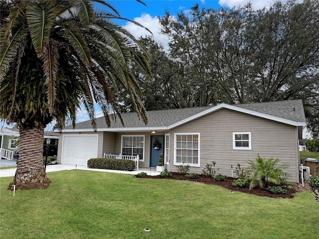 ranch-style house featuring covered porch, a front yard, and a garage