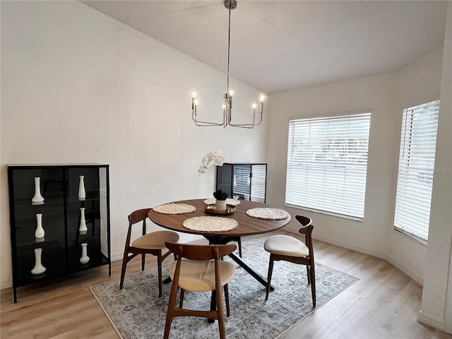 dining space with a chandelier and light hardwood / wood-style flooring