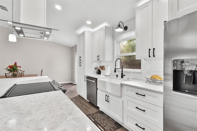 kitchen with white cabinets, appliances with stainless steel finishes, sink, and tasteful backsplash