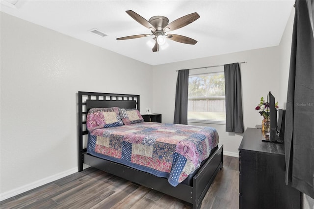 bedroom with ceiling fan and dark hardwood / wood-style floors