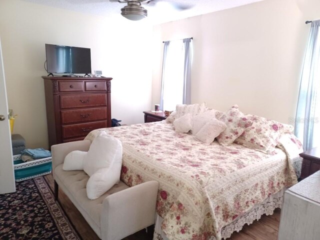 bedroom with dark wood-type flooring and ceiling fan