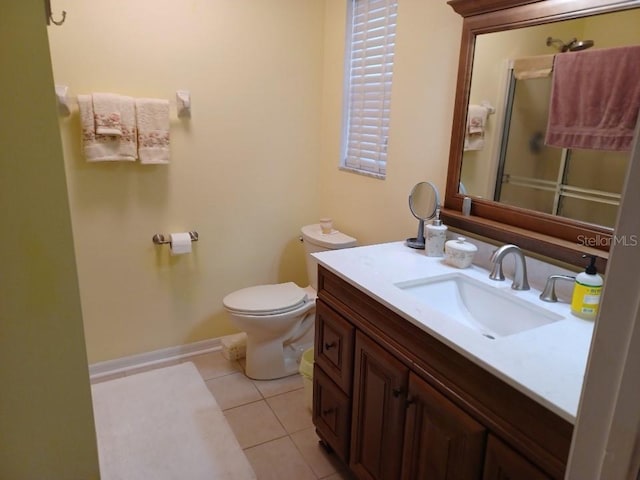 bathroom featuring tile patterned flooring, vanity, and toilet