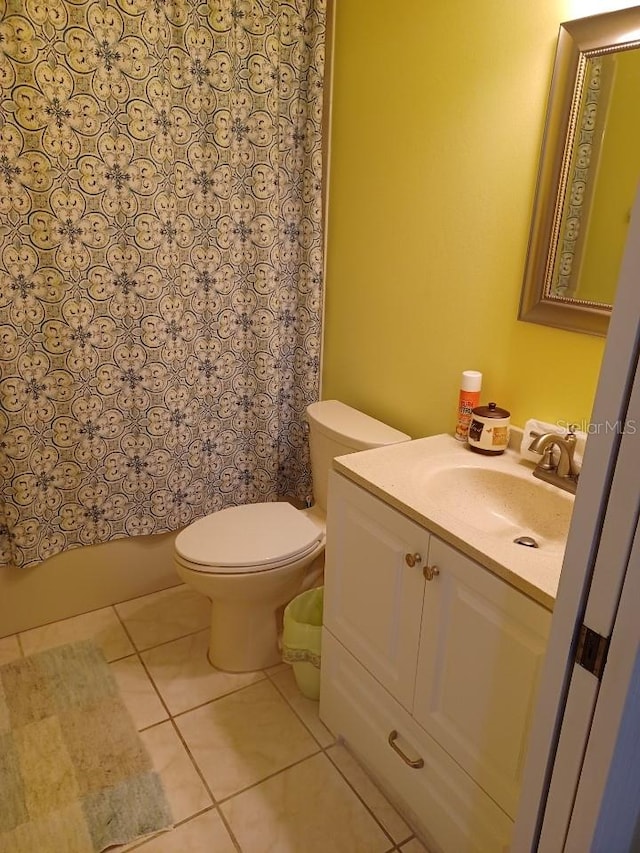 bathroom featuring vanity, toilet, and tile patterned flooring