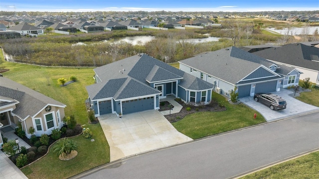 bird's eye view with a residential view and a water view