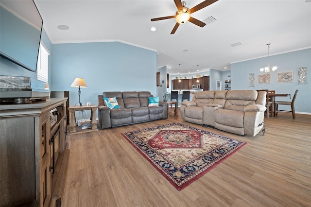 living room featuring light wood finished floors, visible vents, ceiling fan with notable chandelier, and ornamental molding