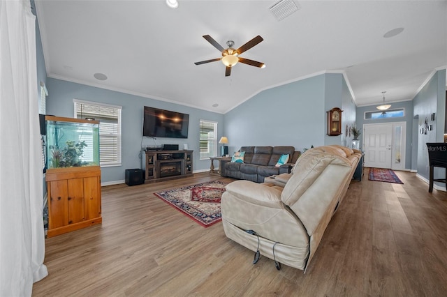 living room featuring visible vents, baseboards, wood finished floors, and a ceiling fan