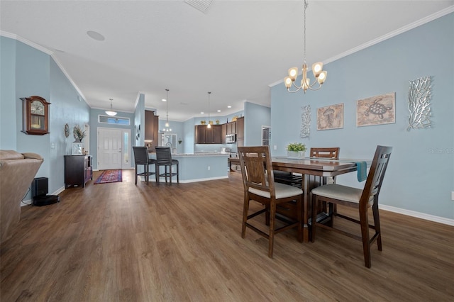 dining room with a notable chandelier, ornamental molding, baseboards, and dark wood-style flooring