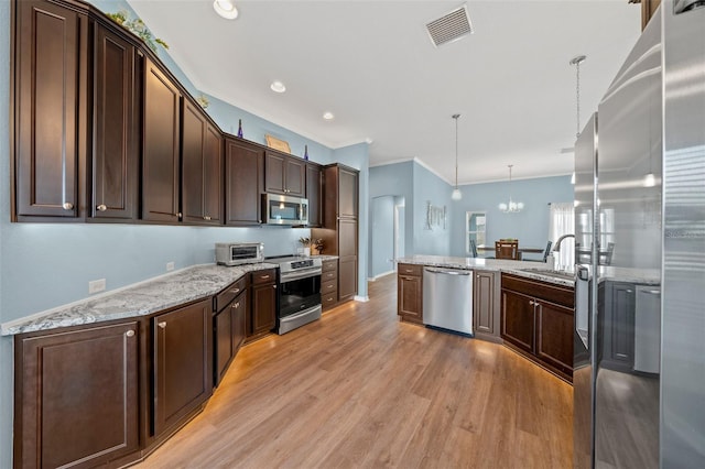 kitchen with visible vents, a notable chandelier, a sink, appliances with stainless steel finishes, and dark brown cabinets