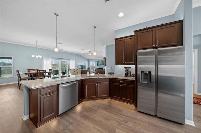 kitchen featuring dark brown cabinetry, light wood-style flooring, crown molding, and appliances with stainless steel finishes