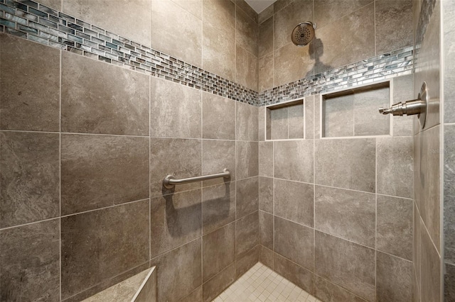 full bath with a tile shower