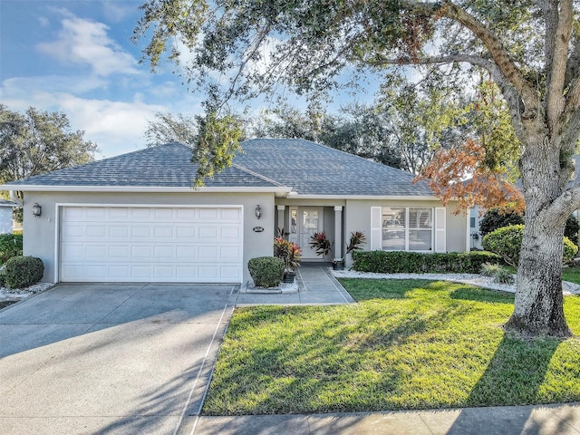 ranch-style house featuring a garage and a front lawn