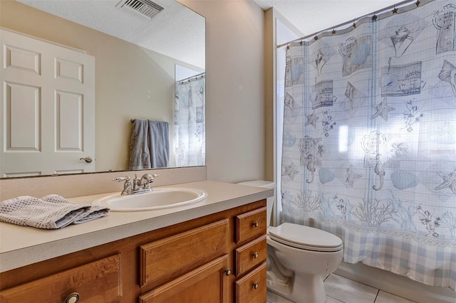 bathroom featuring tile patterned floors, toilet, and vanity