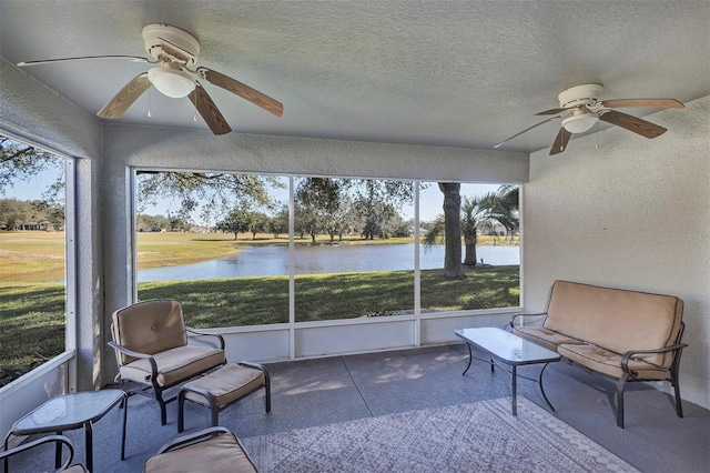 sunroom with a water view and ceiling fan