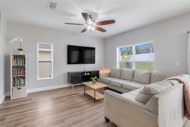 living room with ceiling fan and hardwood / wood-style floors