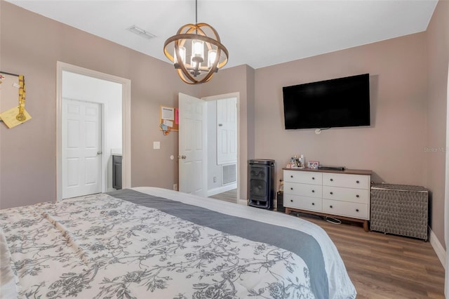 bedroom featuring hardwood / wood-style floors and a notable chandelier