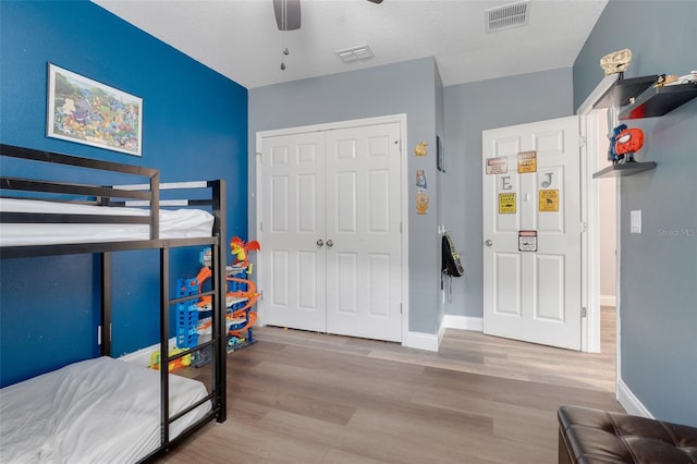 bedroom featuring ceiling fan, a closet, and light hardwood / wood-style flooring