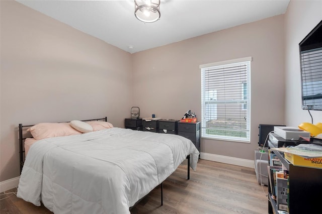 bedroom with hardwood / wood-style floors