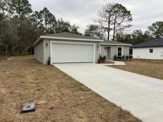 ranch-style home with a garage and a front yard