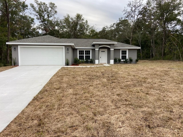 ranch-style house featuring a garage and a front yard