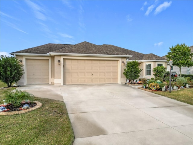 ranch-style house featuring a garage and a front lawn