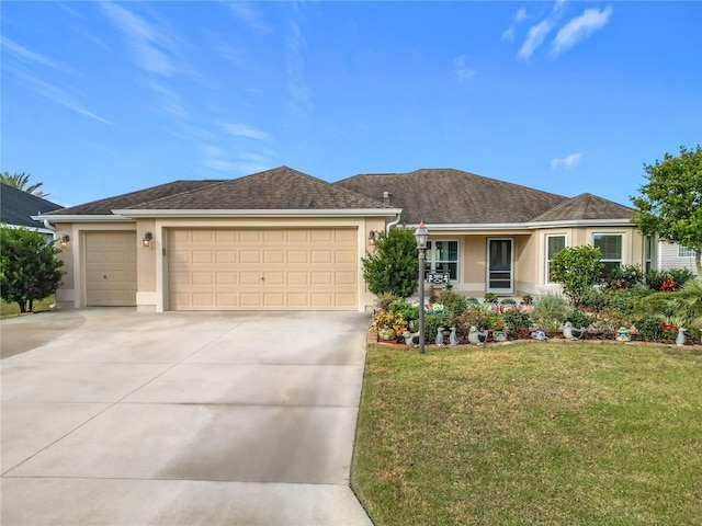 ranch-style house featuring a front yard and a garage