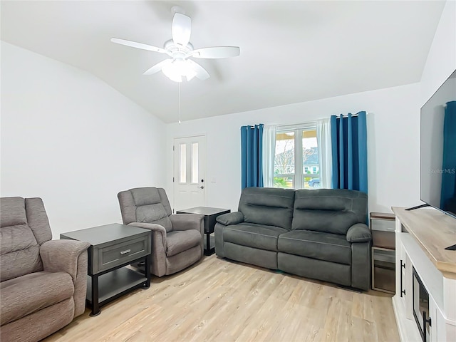 living room featuring lofted ceiling, ceiling fan, and light wood-type flooring