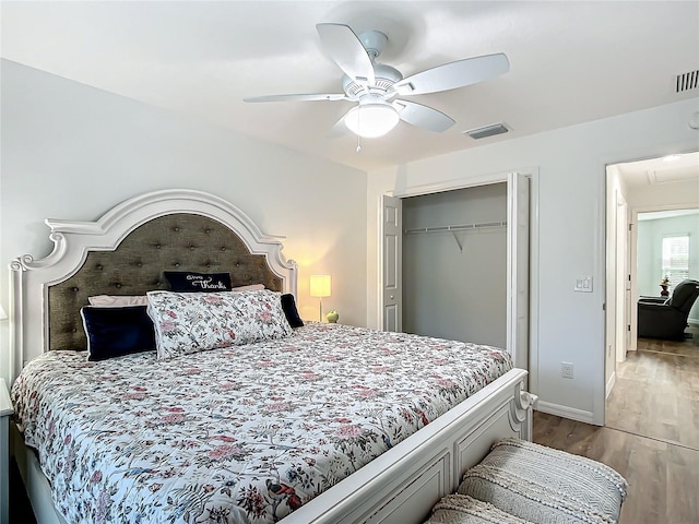 bedroom with ceiling fan, a closet, and hardwood / wood-style flooring