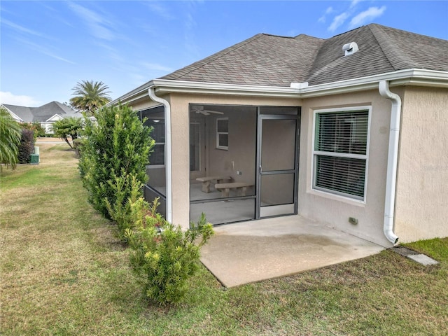 entrance to property with a patio area and a yard