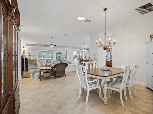 dining space with ceiling fan with notable chandelier and ornamental molding