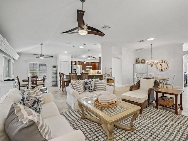 living room featuring ceiling fan with notable chandelier