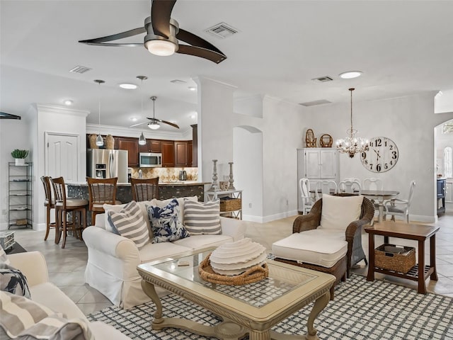 tiled living room with crown molding and ceiling fan with notable chandelier