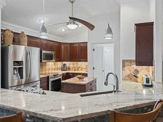 kitchen featuring sink, light stone counters, tasteful backsplash, hanging light fixtures, and stainless steel appliances