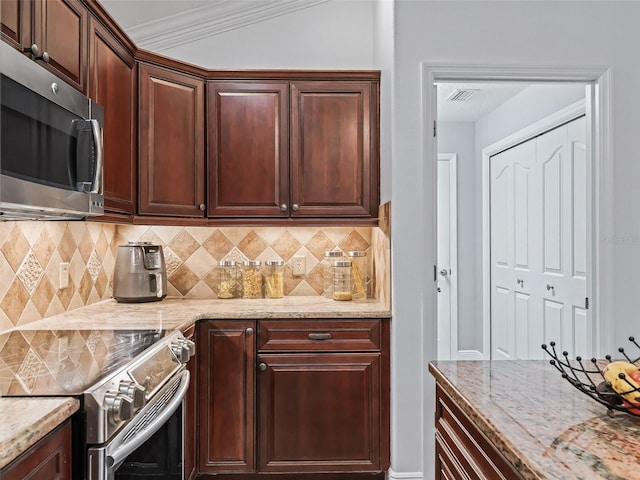 kitchen featuring ornamental molding, stainless steel appliances, light stone countertops, and decorative backsplash