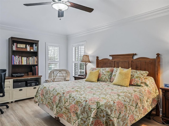 bedroom featuring ceiling fan, ornamental molding, and light wood-type flooring