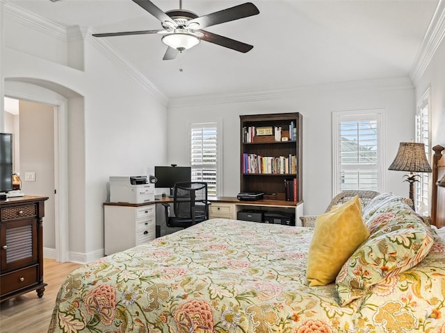 bedroom with multiple windows, crown molding, ceiling fan, and light hardwood / wood-style flooring