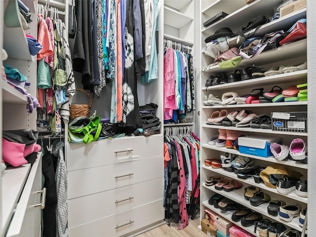 spacious closet featuring light hardwood / wood-style floors