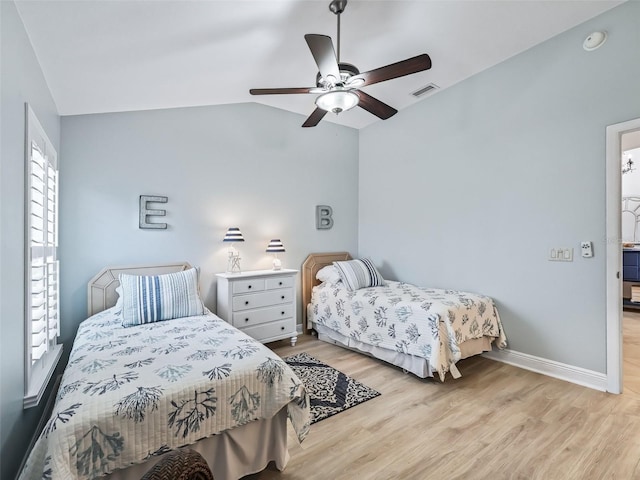 bedroom with lofted ceiling, light hardwood / wood-style floors, and ceiling fan