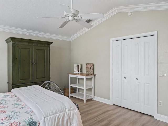 bedroom featuring ceiling fan, ornamental molding, and light hardwood / wood-style flooring