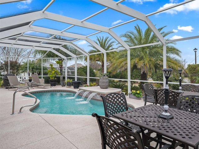 view of pool with a patio, pool water feature, and a lanai